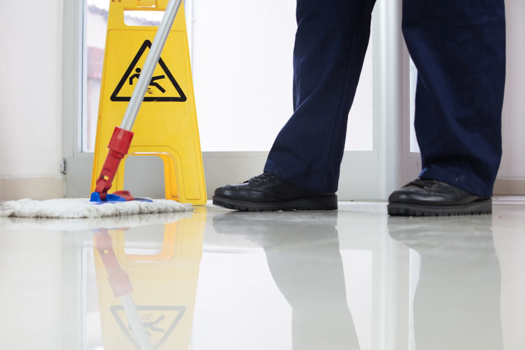 Professional floor cleaning with a clear safety sign
