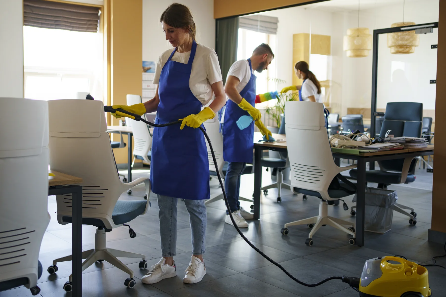 Professional cleaning team working through a modern office